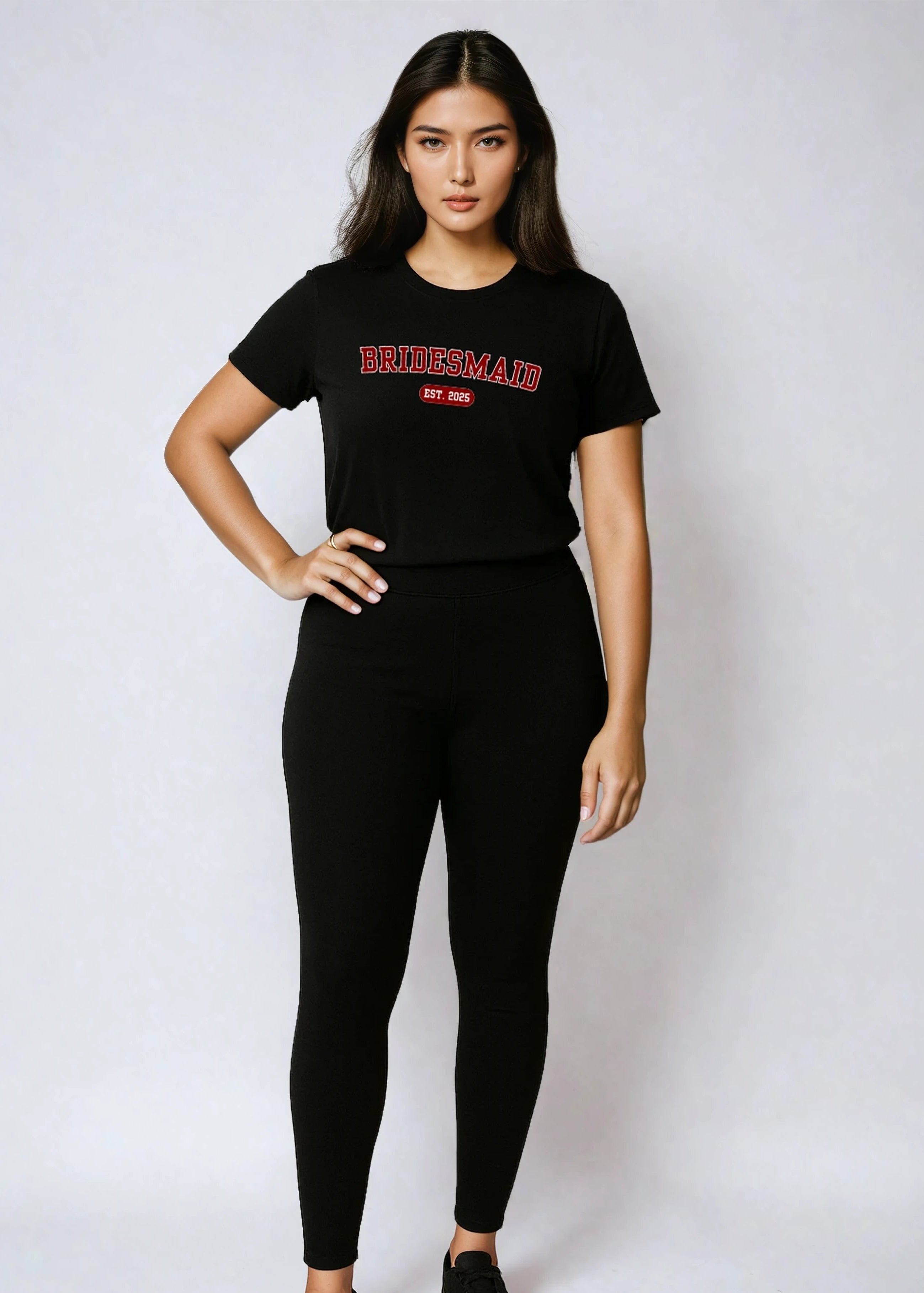 Woman wearing a black t-shirt with text and black leggings on a white background