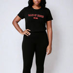 Woman wearing a black t-shirt and leggings with text on a white background
