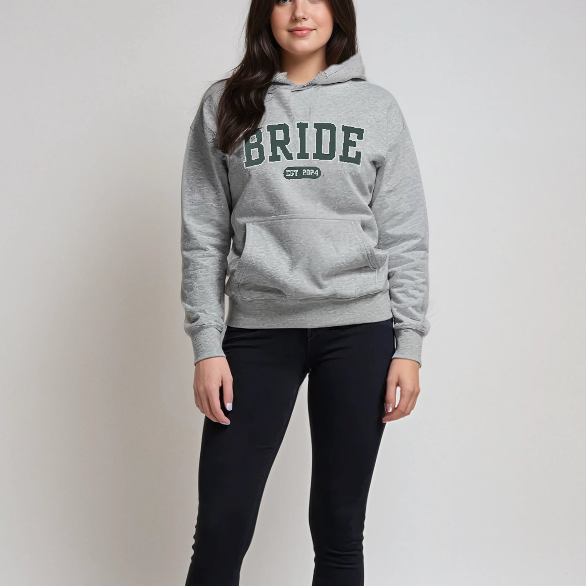 Woman wearing a gray hoodie with 'BRIDE' text on a plain background