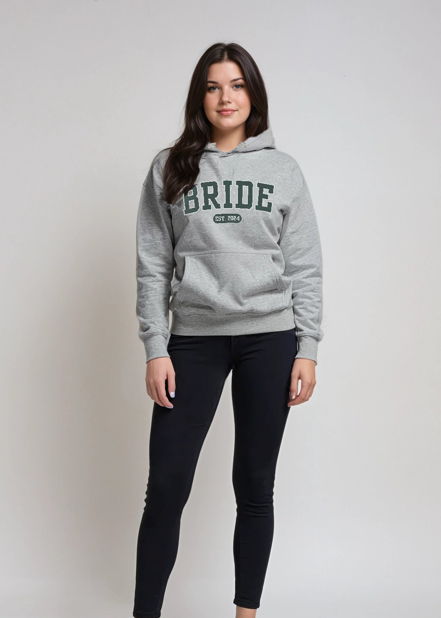 Woman wearing a gray hoodie with 'BRIDE' text on a plain background