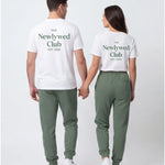 Model wearing Newlywed Club T-Shirt - Alpine Green Logo